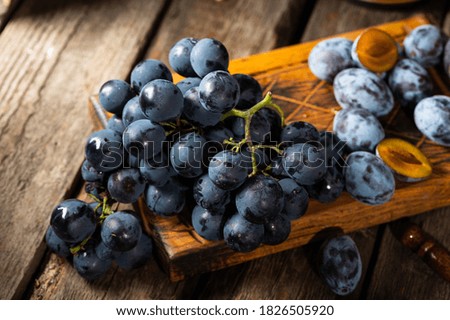 Grapes on a old wooden table. Blue grape. Black grape. Vine grape. Still life of food