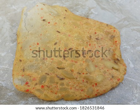 Homemade crunchy and delicious indian aaloo zeera papad(chips) closeup picture