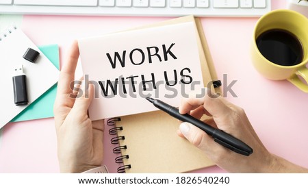 WORK WITH US message on the card shown by a businesswoman