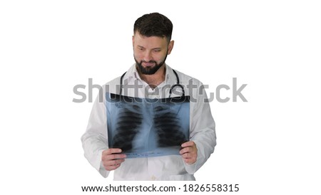 Medical doctor walking and looking at x-ray picture of lungs on