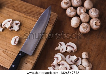sliced mushroom on chopping board with a knife