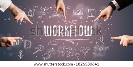 Close-Up of cropped hand pointing at WORKFLOW inscription, modern business solution concept