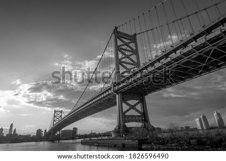  ben franklin bridge at sunset across from philadelphia in black and white