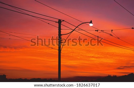 A sunset behind city wires.