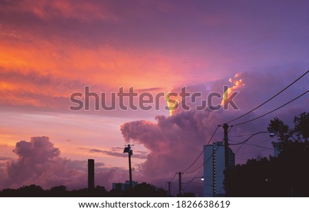 Fluffy clouds in an intense, summer sunset in Toronto.