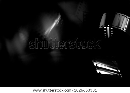 35mm film in black and white. Abstract blurry background with photographic film. Black and white background.