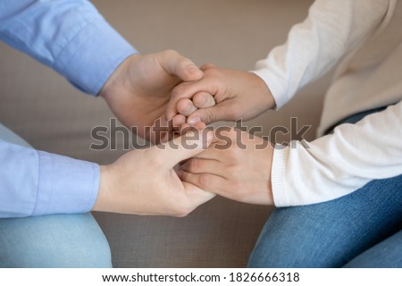I am with you. Close up of young man husband, friend, brother holding tender female palms in hands demonstrating support and care, sharing her feelings, begging forgiveness, reconciling after conflict Royalty-Free Stock Photo #1826666318