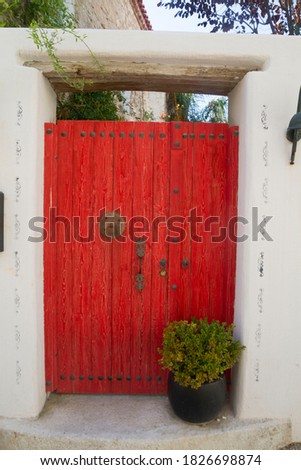 Red garden door and flowerpot