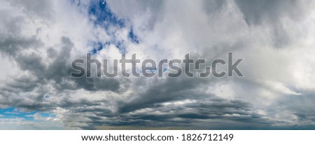 Fantastic dark thunderclouds, natural sky composition, wide panorama