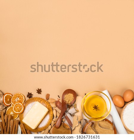 Christmas gingerbread cookies cooking background flat lay top view template with copy space for text. Baking utensils, spices and food ingredients on brown paper background