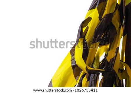 Used protective black and yellow tape isolated on white background. Caution, danger