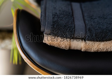 colored towels lie on a leather chair