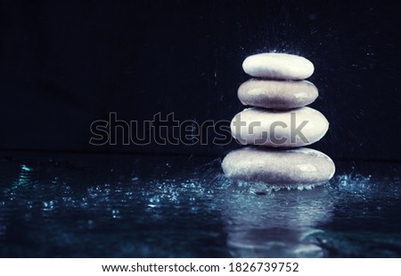 Pyramid of spa stones on dark background, Zen stones