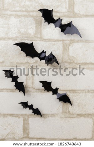 Bats on a white brick wall. Decoration for Halloween party