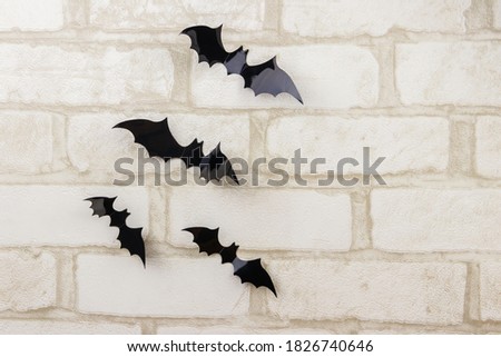 Bats on a white brick wall. Decoration for Halloween party