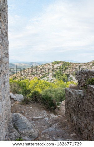 Serra d'Irta natural park, Alcossebre, Costa del Azahar, Spain. Beautiful protected area, contrasted by mountains and clouds. Picture taken from Santa Magdalena de Polpis castle ruins. Vertical shot.