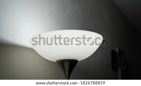 the lamp illuminates the room and gives a flash to the wall               