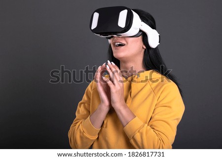 Beautiful woman touching air during the VR experience isolated on black background