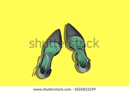 Black womens shoes on a yellow background with a copy of the space. Women's blog. Top view, flat layout