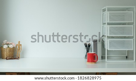 Contemporary workspace with stationery, supplies, decoration and copy space on white desk.