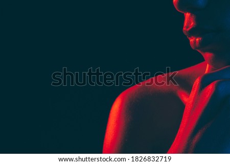 Male silhouette. Neon light. Unrecognizable black man with strong shoulder hand on chin isolated on dark copy space. Masculine power. Ethnic problems. Human confidence