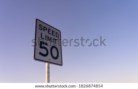 View of Speed Limit Sign on the Side of Road During Early Morning