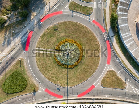 Aerial drone view. Roundabout with red bicycle markings.