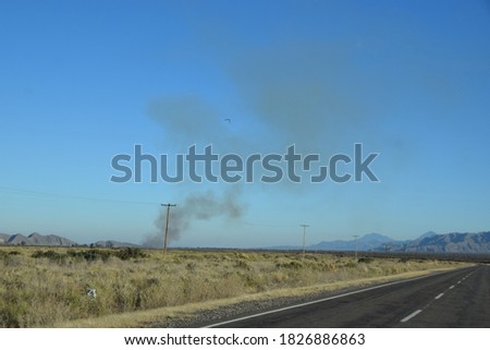 Clouds of smoke over a country road in the Argentine semi-desert