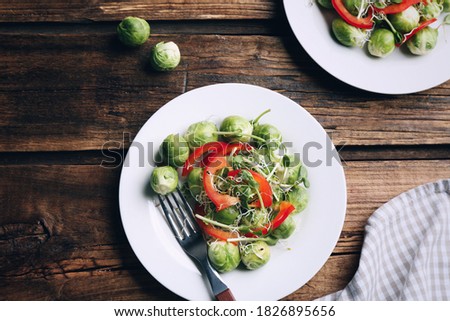 Tasty salad with Brussels sprouts served on wooden table, flat lay. Food photography  