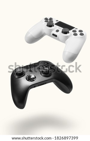 White and black game controllers on white background Royalty-Free Stock Photo #1826897399