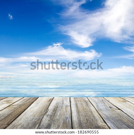 wooden pier sea and sky with clouds