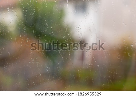 Dirty house window after autumn rain. Natural light, selective focus.