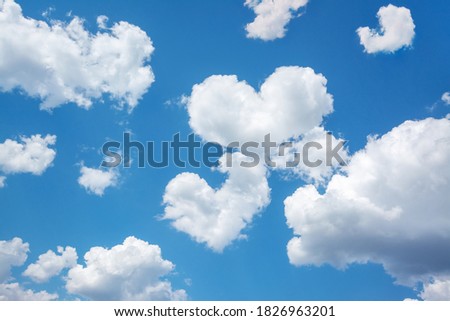 Bright picture of clouds in shape of two hearts between other clouds in blue sky. Concept of love, feelings, relationship between people