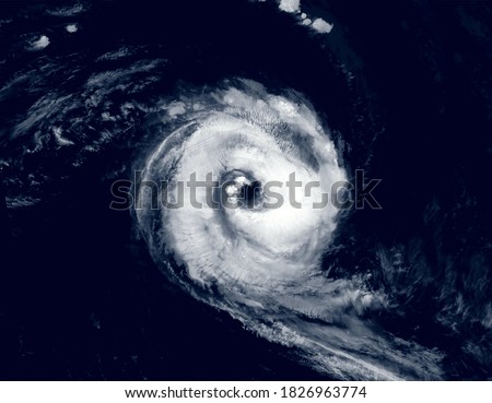 Hurricane eye over sea in satellite photo, view of tropical storm or cyclone from space. Concept of weather, typhoon, disaster, satellite picture and warning. Elements of this image furnished by NASA Royalty-Free Stock Photo #1826963774