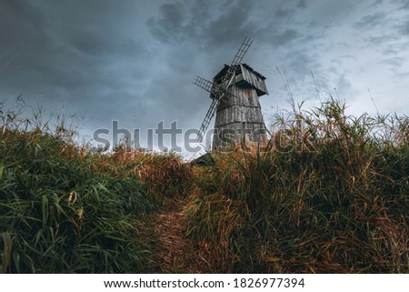Wooden mill. Cloudy autumn day in a countryside mill village.