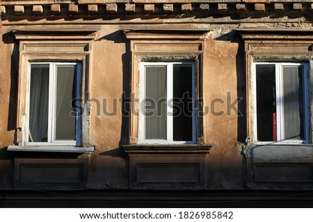 old building facade with windows in sunlight