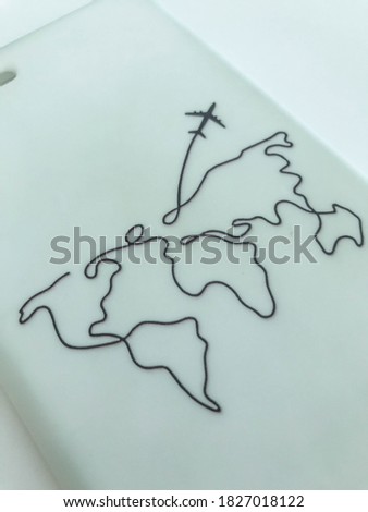 white matte phone case with world map. the plane flies to another continent. black thick lines on the material. rubber texture, smooth homogeneous structure.