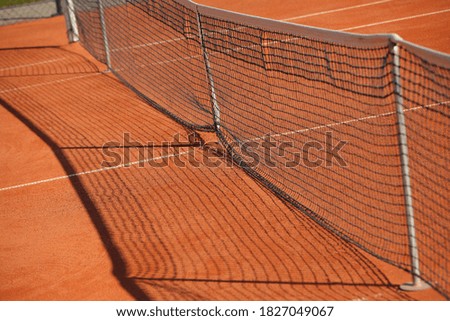 Net tennis court red outdoor clay court.