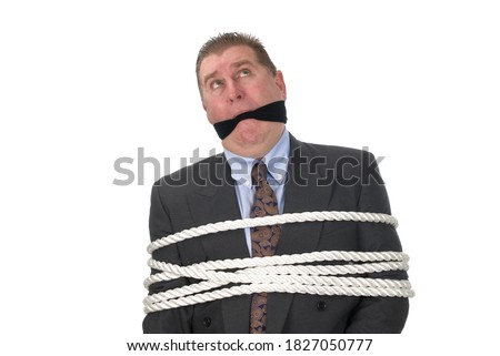 A businessman tied up with white rope and gagged. Royalty-Free Stock Photo #1827050777