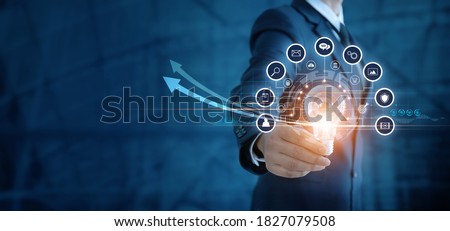 Businessman holding light bulb and analyzing sales data and economic growth graph. Technology and icon customer global network connection. New idea. creativity and inspiration. digital marketing.

