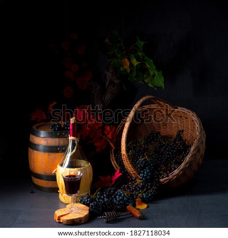 Grapes in the basket with wine and tree leaves