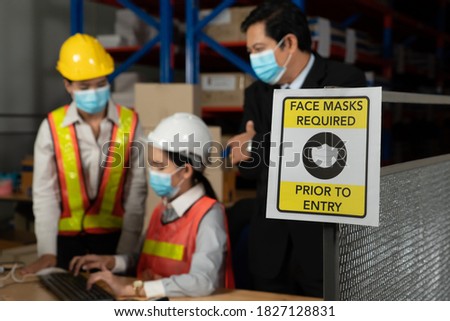 Caution sign in factory warning to industry labor worker to prevent Covid-19 Coronavirus spreading during job business reopening period after epidemic crisis . Working safely concept .