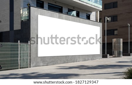Blank advertising billboard on building wall useful for products advertisement