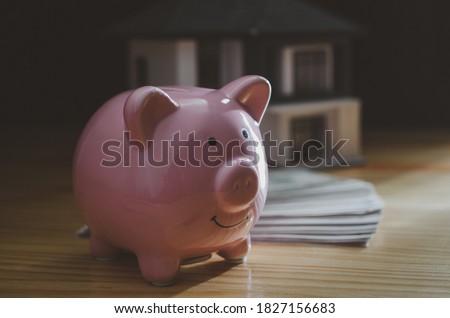 Piggy Bank on wood table.money saving financial concept.