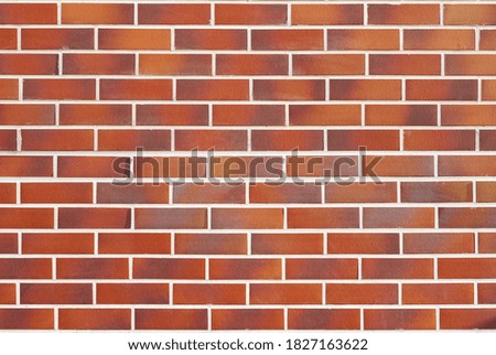 The wall is made of smooth brick. Brick wall, texture. Decorative brickwork in various shades.