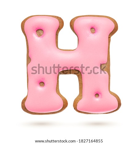 Capital letter H. Pink gingerbread biscuit isolated on white background. Christmas decoration