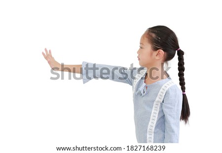 asian little child girl showing five finger stop gesture and looking straight beside isolated on white background. Side view.