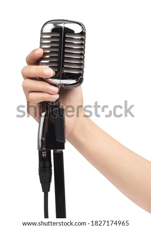 hand holding a single retro microphone isolated on white background