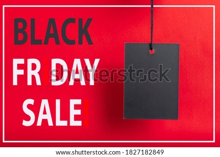 Black friday sale concept. Black Sale tag color on the red background with Copy space.