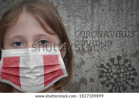 Little girl in medical mask with flag of peru stands near the old vintage wall with text coronavirus, covid, and virus picture. Stop virus